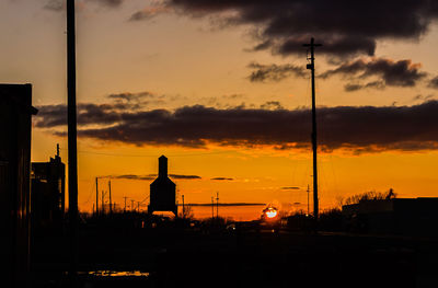 Silhouette of built structure against cloudy sky