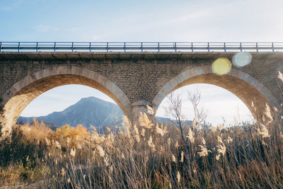 Low angle view of arch bridge against sky