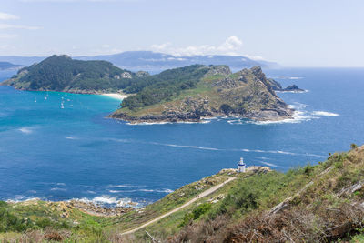 Scenic view of bay against sky with a lighthouse in cíes islands
