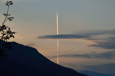 Low angle view of silhouette mountains against sky