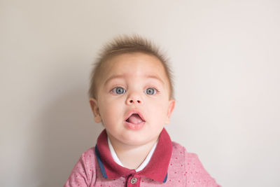 Portrait of cute baby against white background