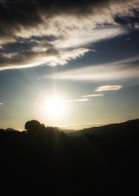 Silhouette landscape against sky during sunset