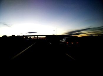 Cars on road at sunset