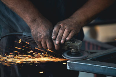 Midsection of man working in workshop