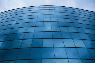 Low angle view of modern building against blue sky