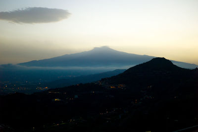 Scenic view of mountains against sky at night