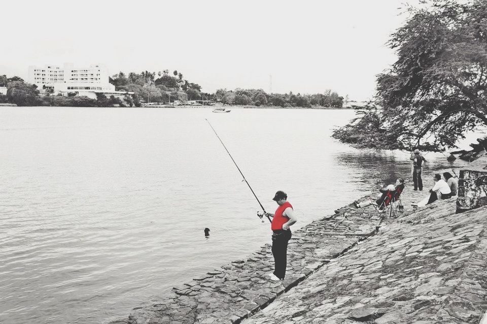 water, lifestyles, leisure activity, full length, men, boys, childhood, clear sky, rear view, sea, person, river, day, tree, nature, built structure, casual clothing, walking