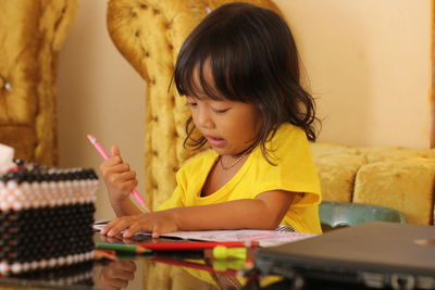 Close-up of cute girl playing piano