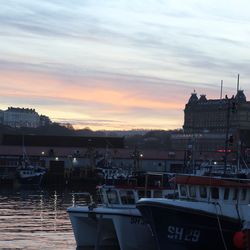 Buildings in city at sunset