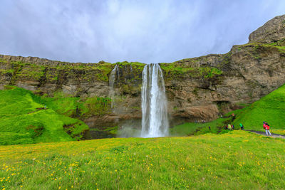 Scenic view of waterfall against sky