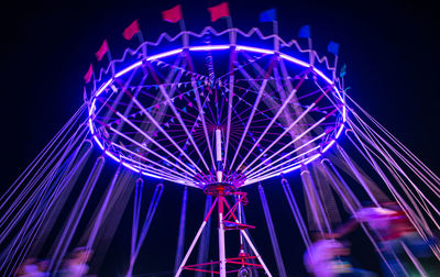 Low angle view of illuminated amusement park ride