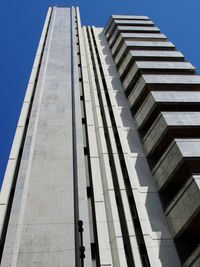 Low angle view of modern building against clear blue sky