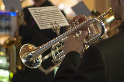 Midsection of man playing trumpet 