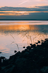 Scenic view of lake against sky during sunset
