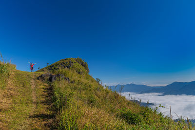 Scenic view of mountains against blue sky