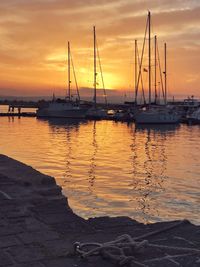 Sailboats in marina at sunset