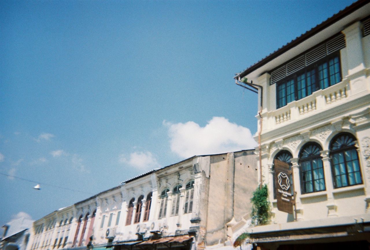 LOW ANGLE VIEW OF BUILDING AGAINST BLUE SKY