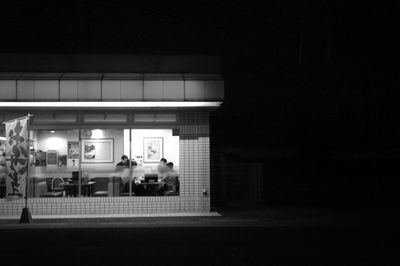 Woman in illuminated building