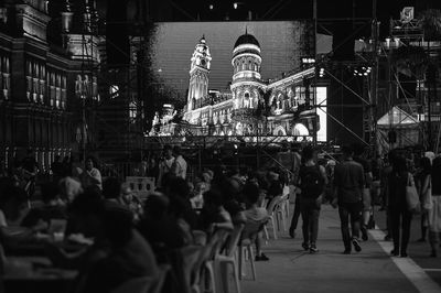 People on city street against projector screen