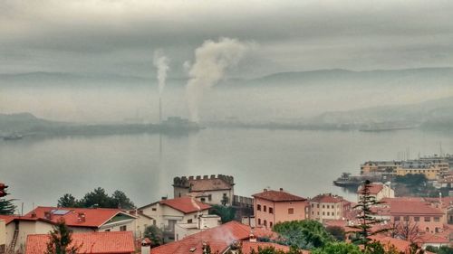 High angle view of town against cloudy sky