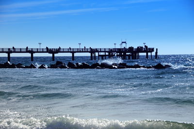 Pier over sea against sky