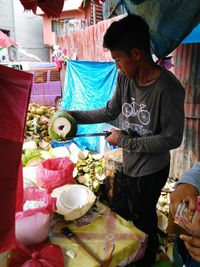 Full length of boy standing in market