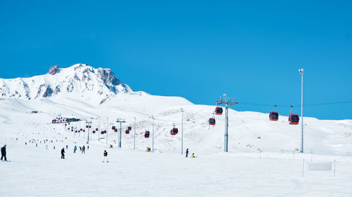 Chairlift on the snow covered ski slope. bright winter sunny day at ski resort. erciyes, kayseri