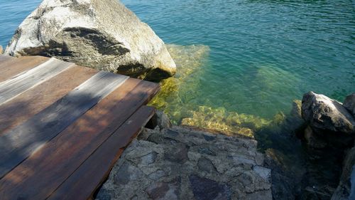 High angle view of rock formation by sea against sky