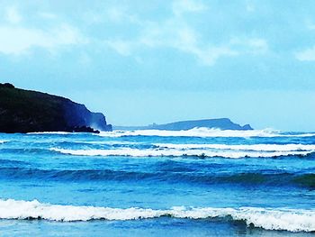 Scenic view of sea against blue sky