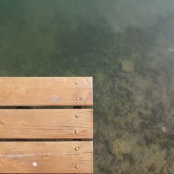 High angle view of wooden post on table against wall