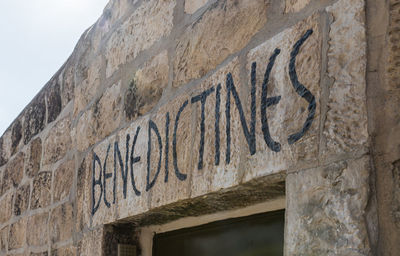 Low angle view of text on old building