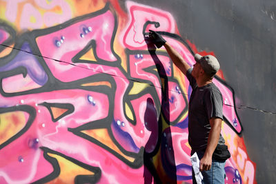 Rear view of people walking on wall