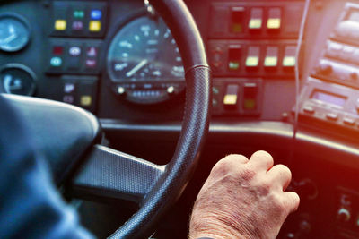 Cropped hand of man driving vehicle