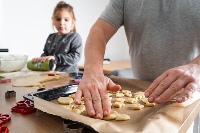 Midsection of man preparing food on table