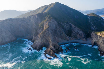 Scenic view of sea and mountains against sky