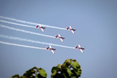 Low angle view of airplane flying against clear sky