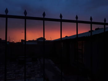 Silhouette of city against sky during sunset