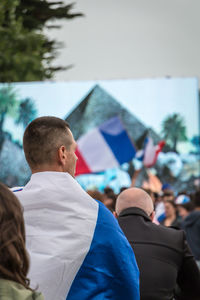 Rear view of man with arms raised