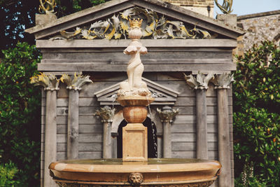 Fountain against wooden built structure at park