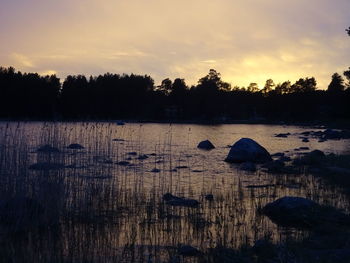 Scenic view of lake against sky during sunset