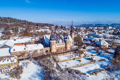 High angle view of townscape against blue sky during winter