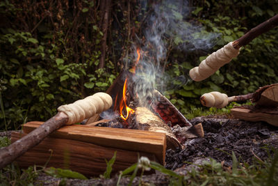 High angle view of bonfire on wooden log