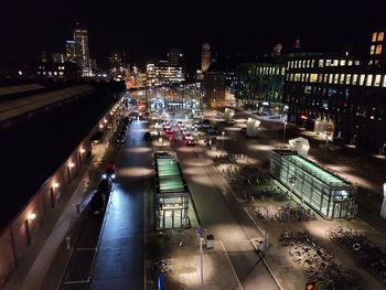 High angle view of illuminated street amidst buildings at night