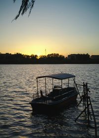 Boat in sea at sunset