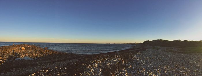 Scenic view of sea against clear blue sky