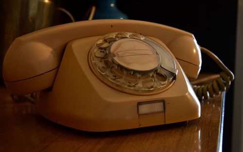 Close-up of telephone booth on table