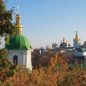 Cathedral by buildings against clear sky