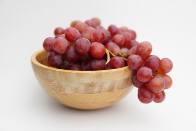 Close-up of grapes over white background