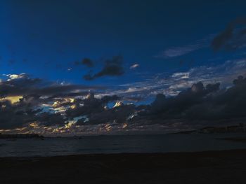 Scenic view of sea against dramatic sky during sunset