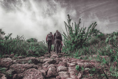 People on landscape against sky